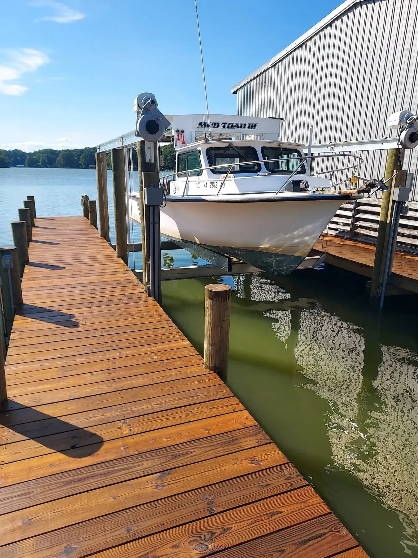 Boat on a lift beside a new dock