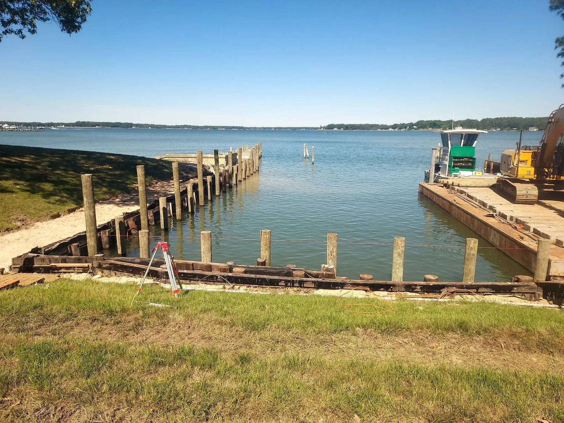 New bulkhead lining a cove with the work barge moored alongside