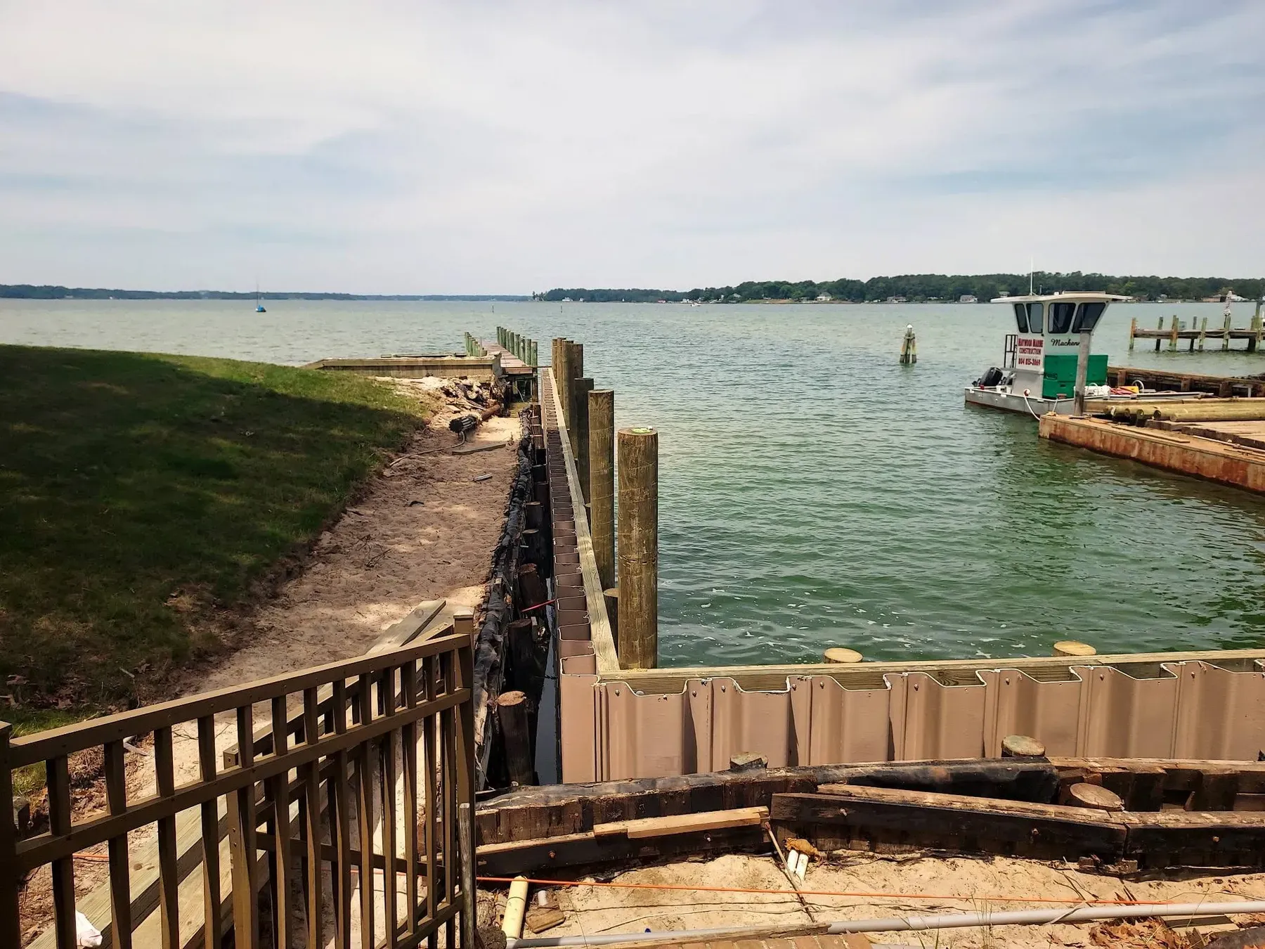 Freshly built bulkhead with a fence along the top of the yard