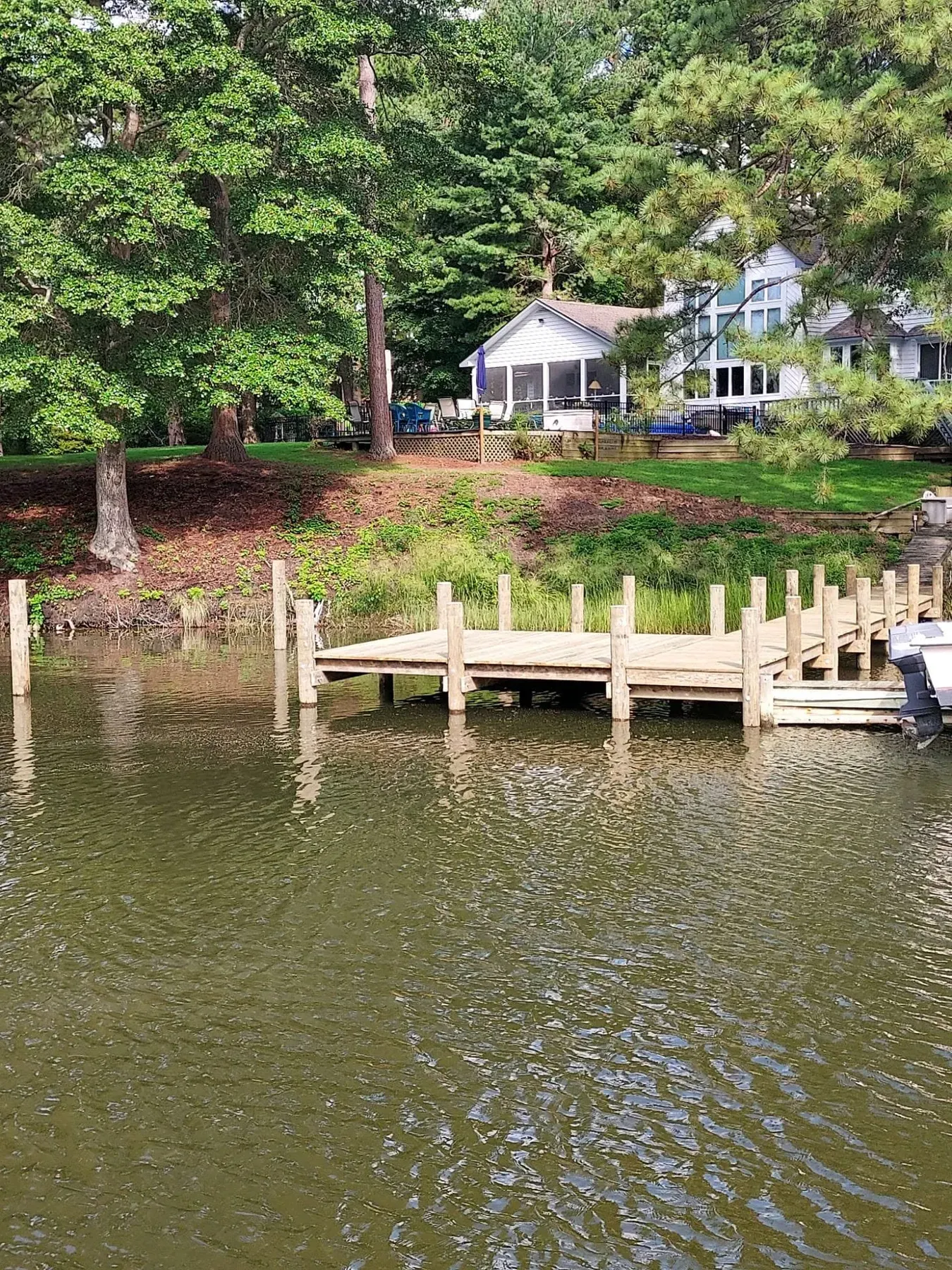 Dock platform below a house in the trees