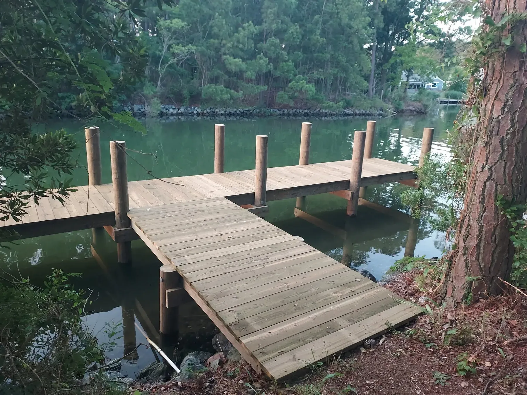 L-shaped dock along a wooded creek bank