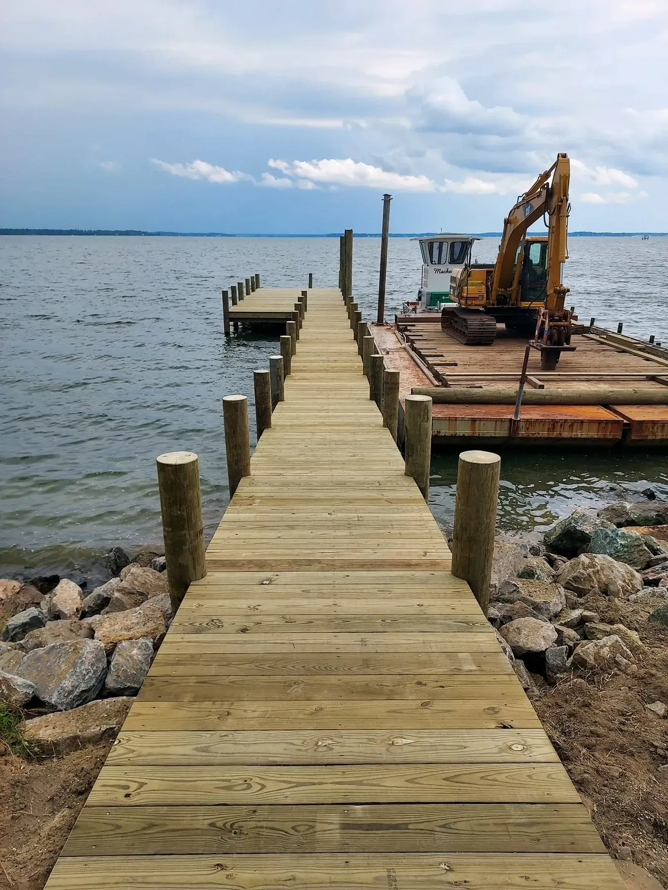 New pier over rip-rap with the barge beyond