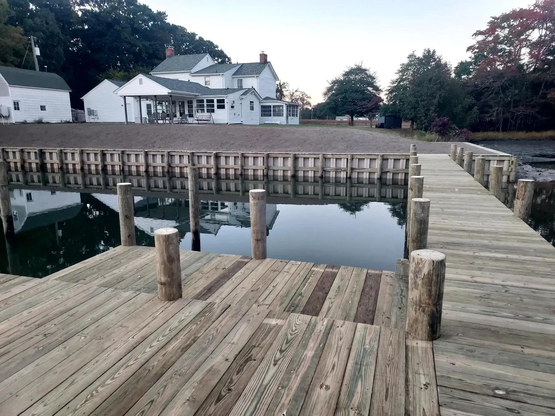 Dock deck along a bulkhead in front of a farmhouse
