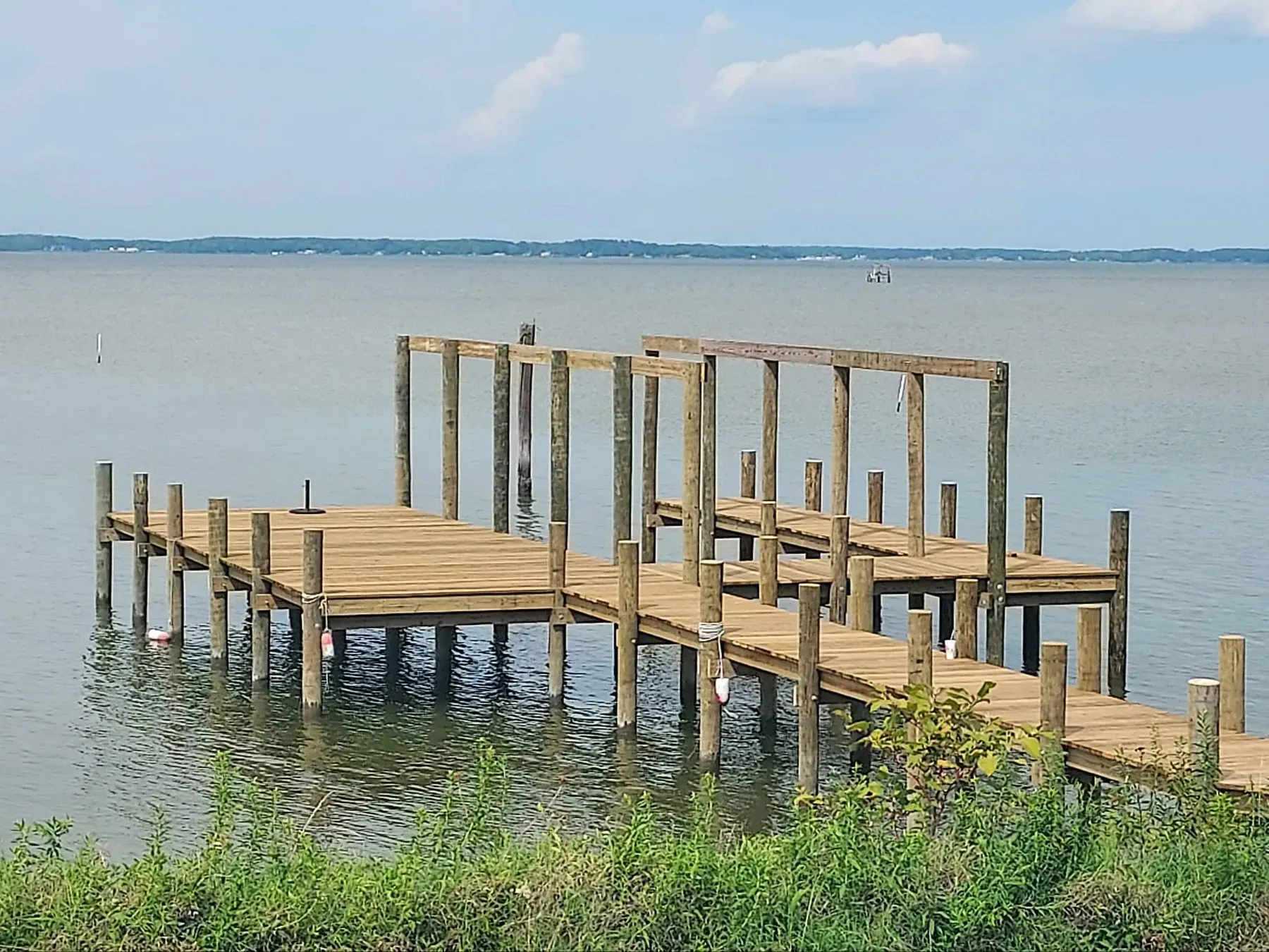 New pier with framing for a boat lift out over open water