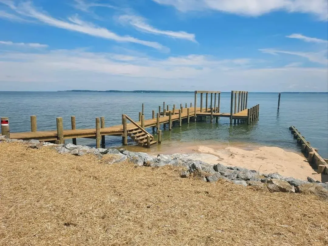 New pier and rip-rap along a sandy bayfront