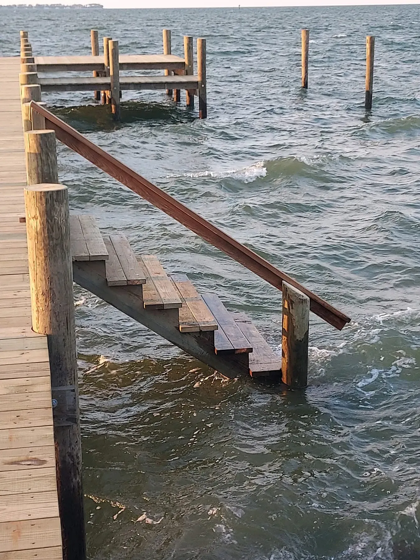 Stairs with a handrail leading down into the water