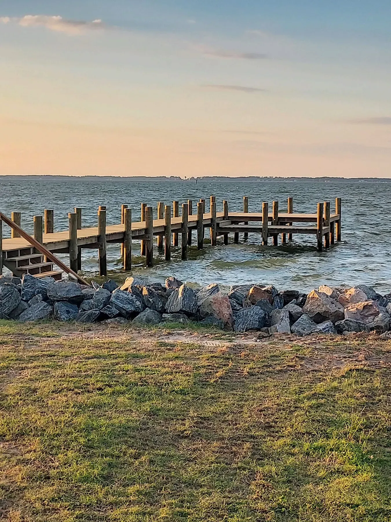 Rock revetment between a lawn and a new pier